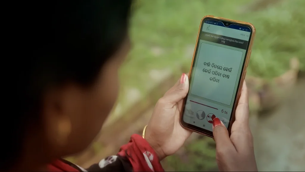 Karya workers documenting their surroundings on their phones outdoors